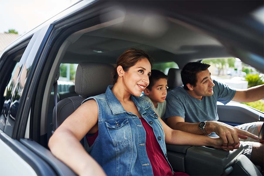 Personal Insurance - Family Looking Up While Sitting in the Family Car and Getting Ready for a Weekend Drive on a Sunny Day